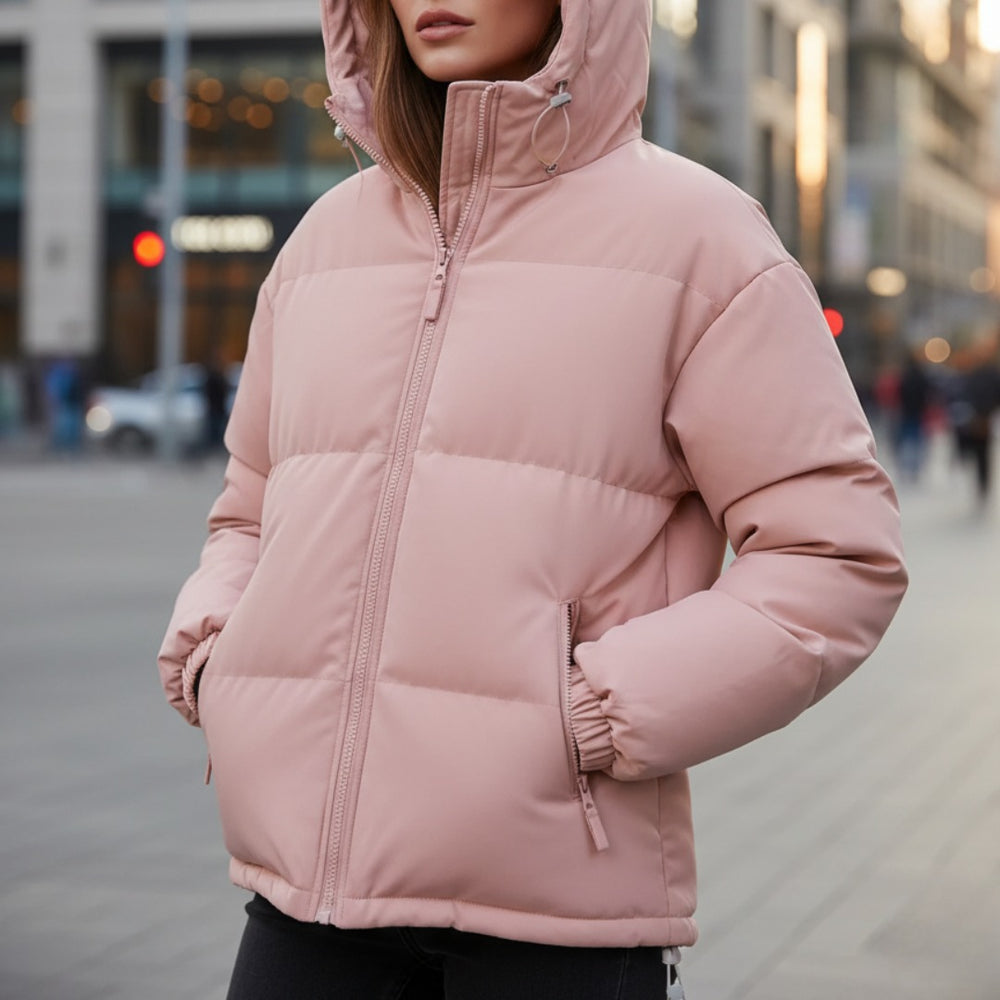 Woman wearing the quilted puffer jacket in Pink on a city street