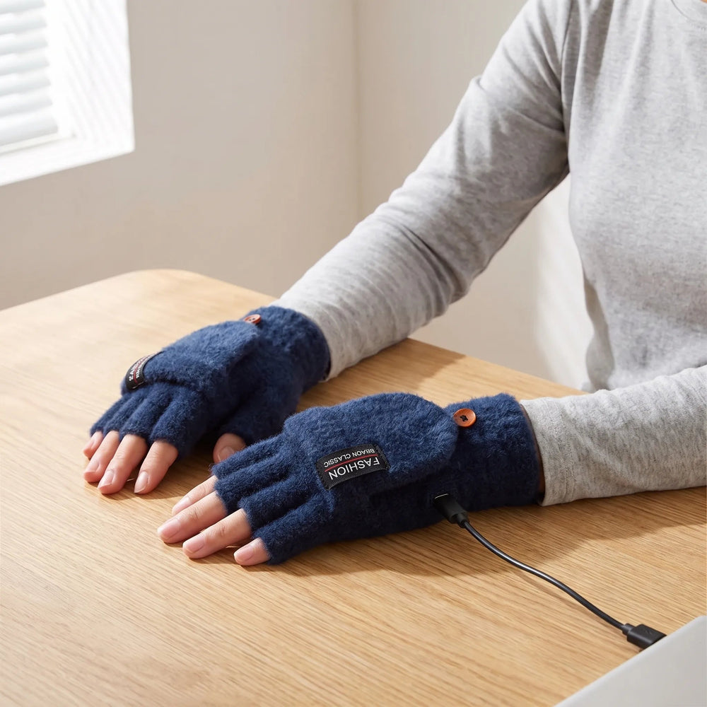 Woman typing at a desk wearing the USB heated gloves in Navy with the cable plugged in