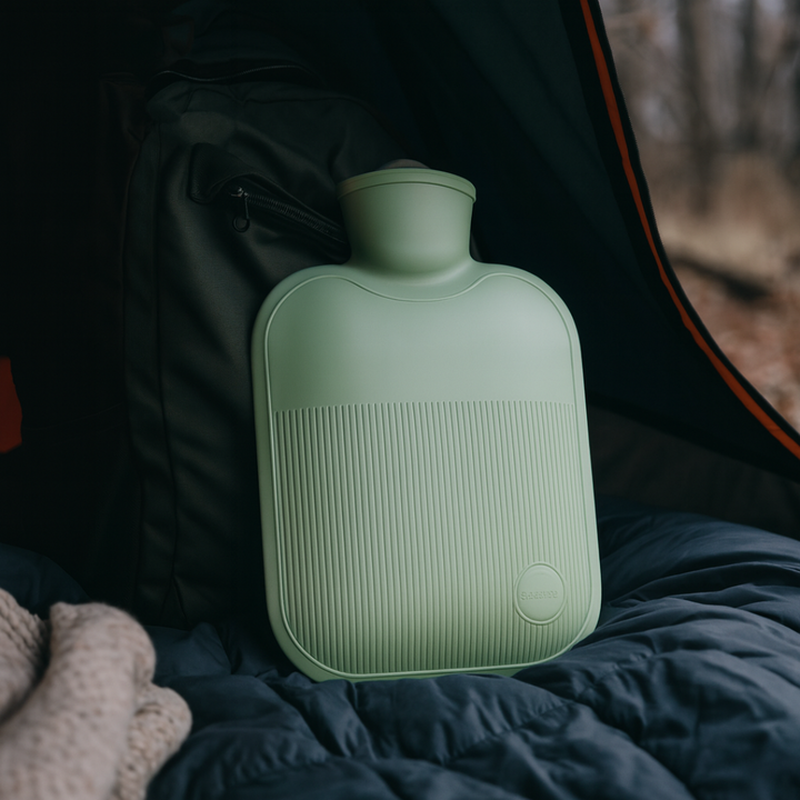 Hot water bottle in Sage Green on a sleeping bag in a tent