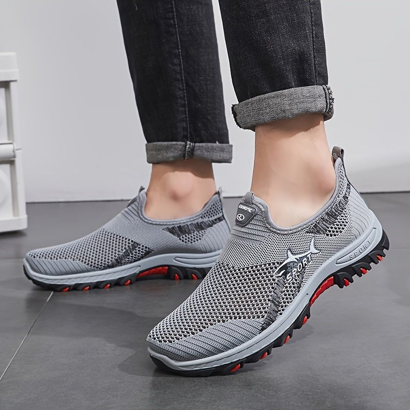 Man wearing the men's slip on walking shoes in Gray