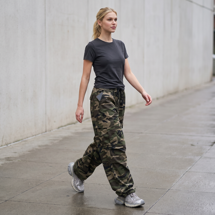 Woman walking a US sidewalk in the camo cargo pants, phone in the hip pocket