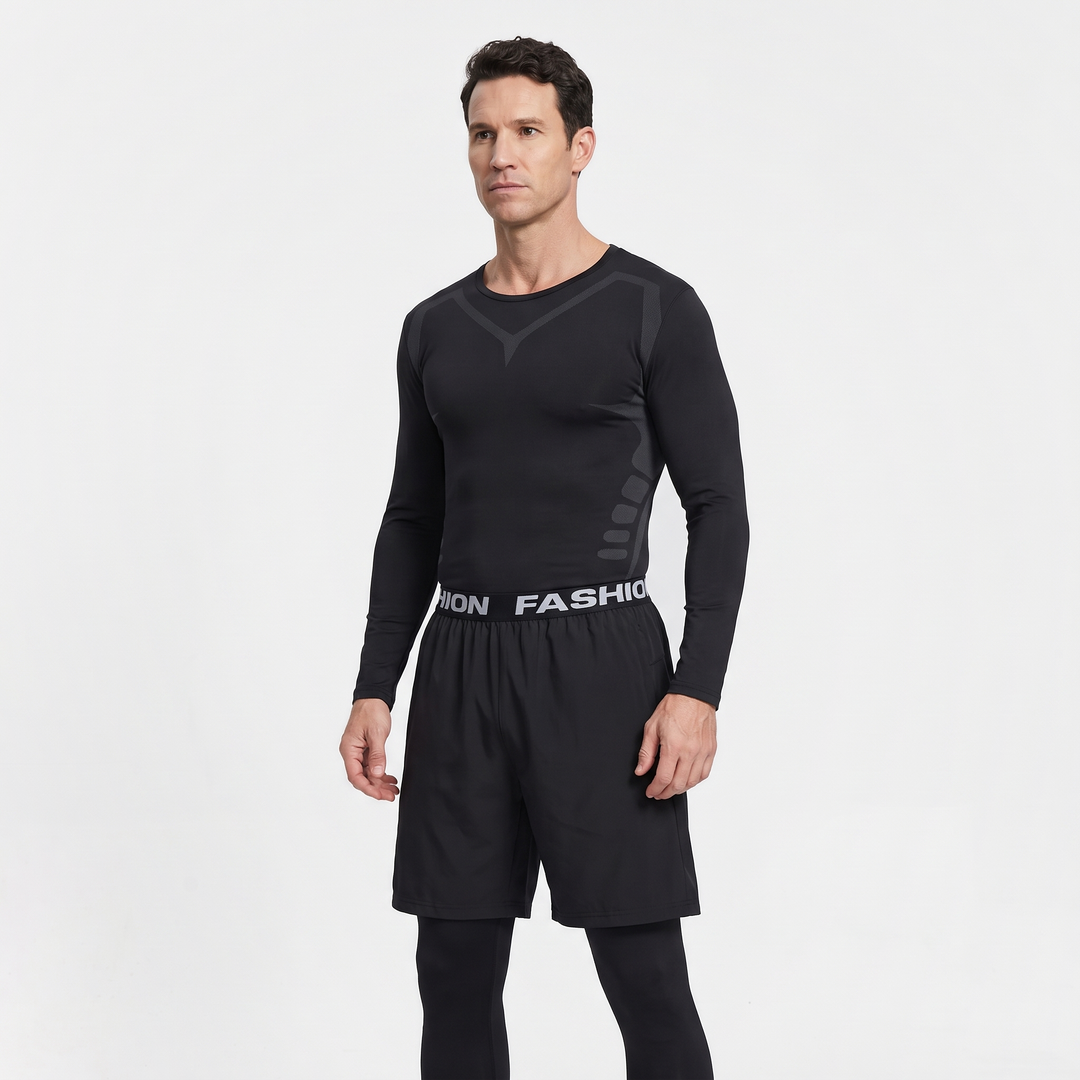 Man wearing the Black base layer top and leggings with shorts over the leggings