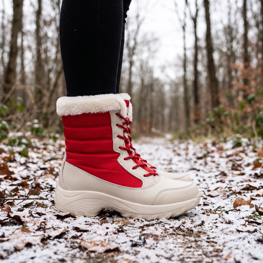 Woman wearing the platform winter boots in Red on a snowy forest path