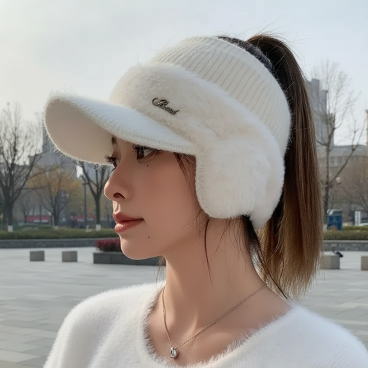 Woman wearing the white ponytail beanie with plush ear warmers