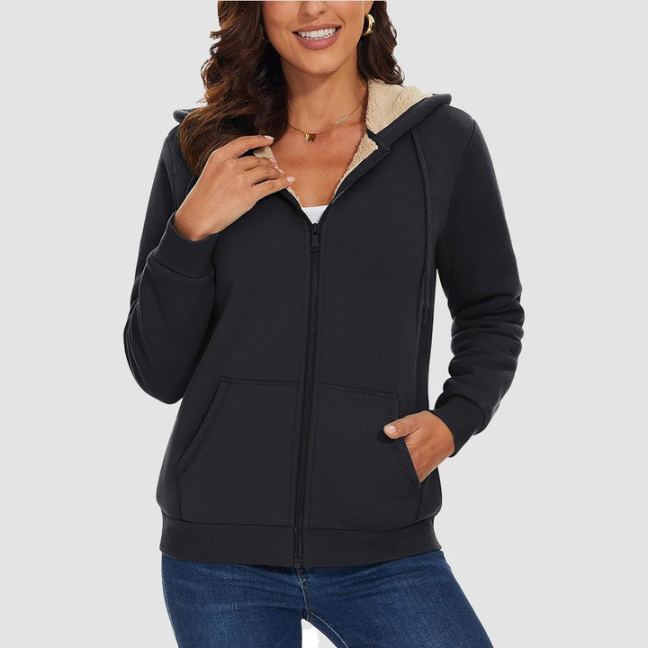 Woman wearing the women's sherpa lined zip up hoodie in Black