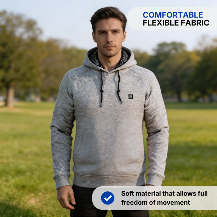 Man wearing the gray heated hoodie outdoors