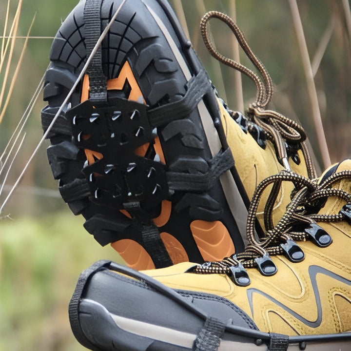 Crampons on a hiking boot on a trail