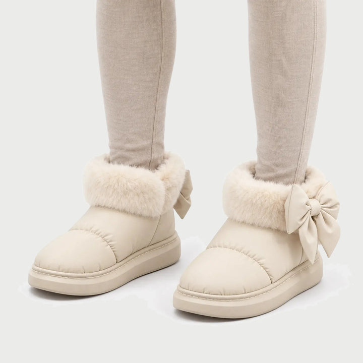Women's winter booties in Cream with faux fur cuff and heel bow