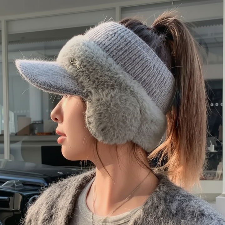 Woman wearing the gray ponytail beanie with plush ear warmers