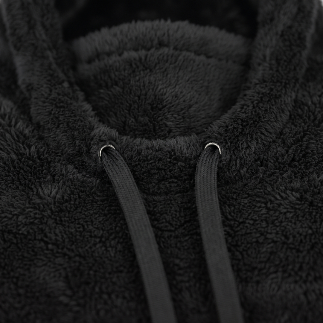 Drawstring cords and eyelets at the front of the neck section, close up
