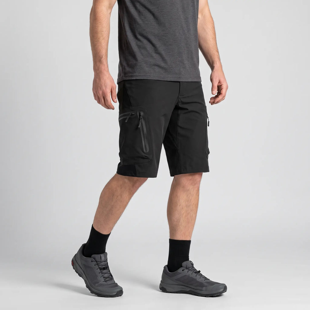 Black MTB shorts worn, three-quarter side view of the zipped cargo pocket