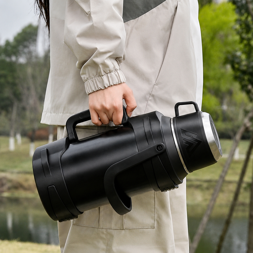 Carrying the large thermos by its folding handle outdoors