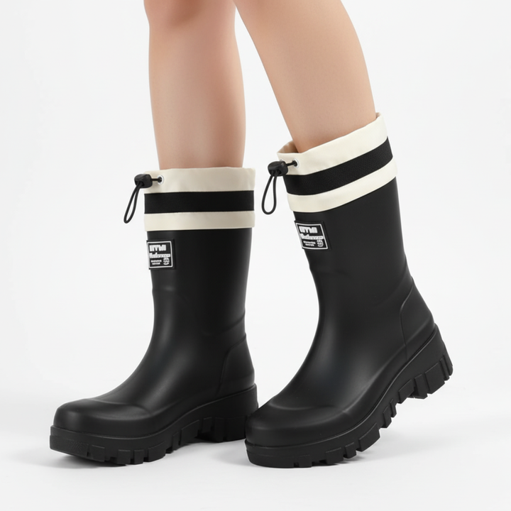 Woman wearing the short platform rain boots in Black