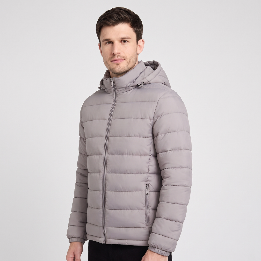 Man wearing the Gray hooded puffer jacket, three-quarter view