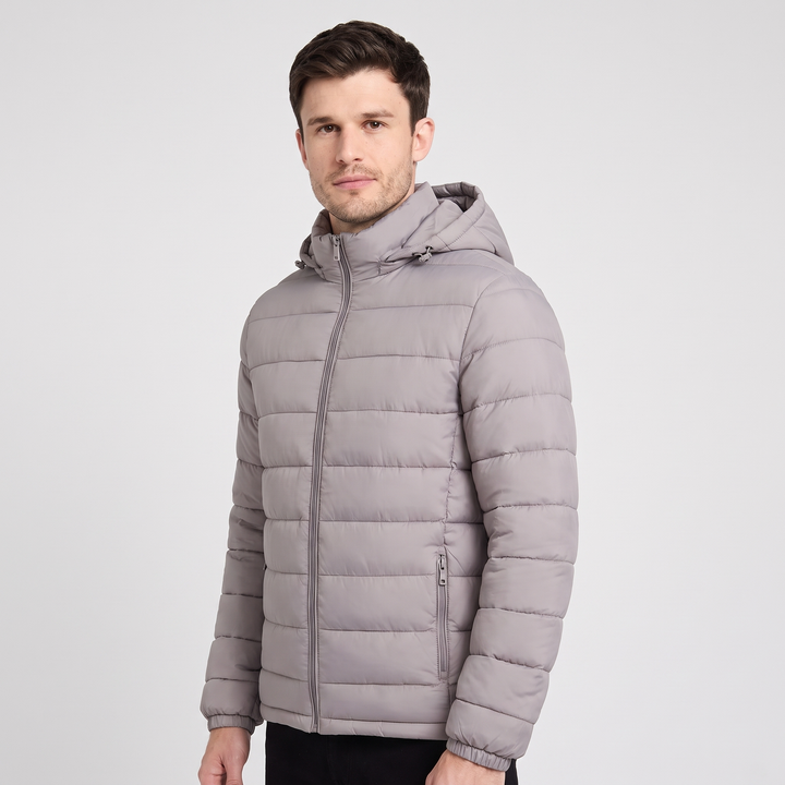 Man wearing the Gray hooded puffer jacket, three-quarter view