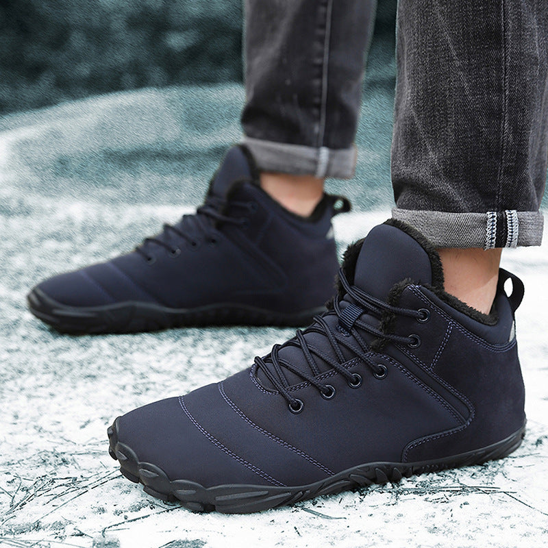 Navy winter barefoot shoes worn on a snowy path