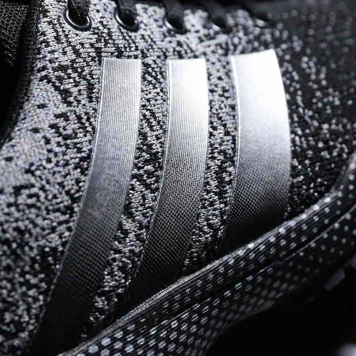 Close up of the heathered knit upper and side stripes of the running shoes