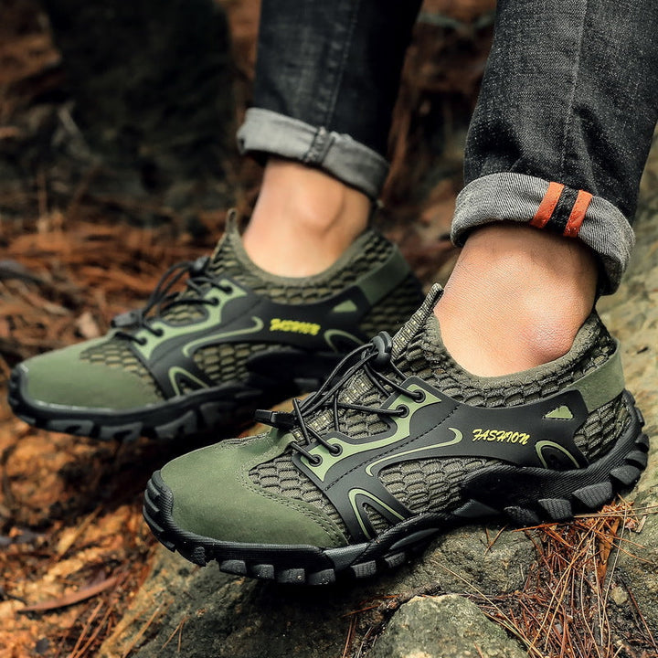SUPERSEDED - Hiker wearing the green water hiking shoes on a rocky trail