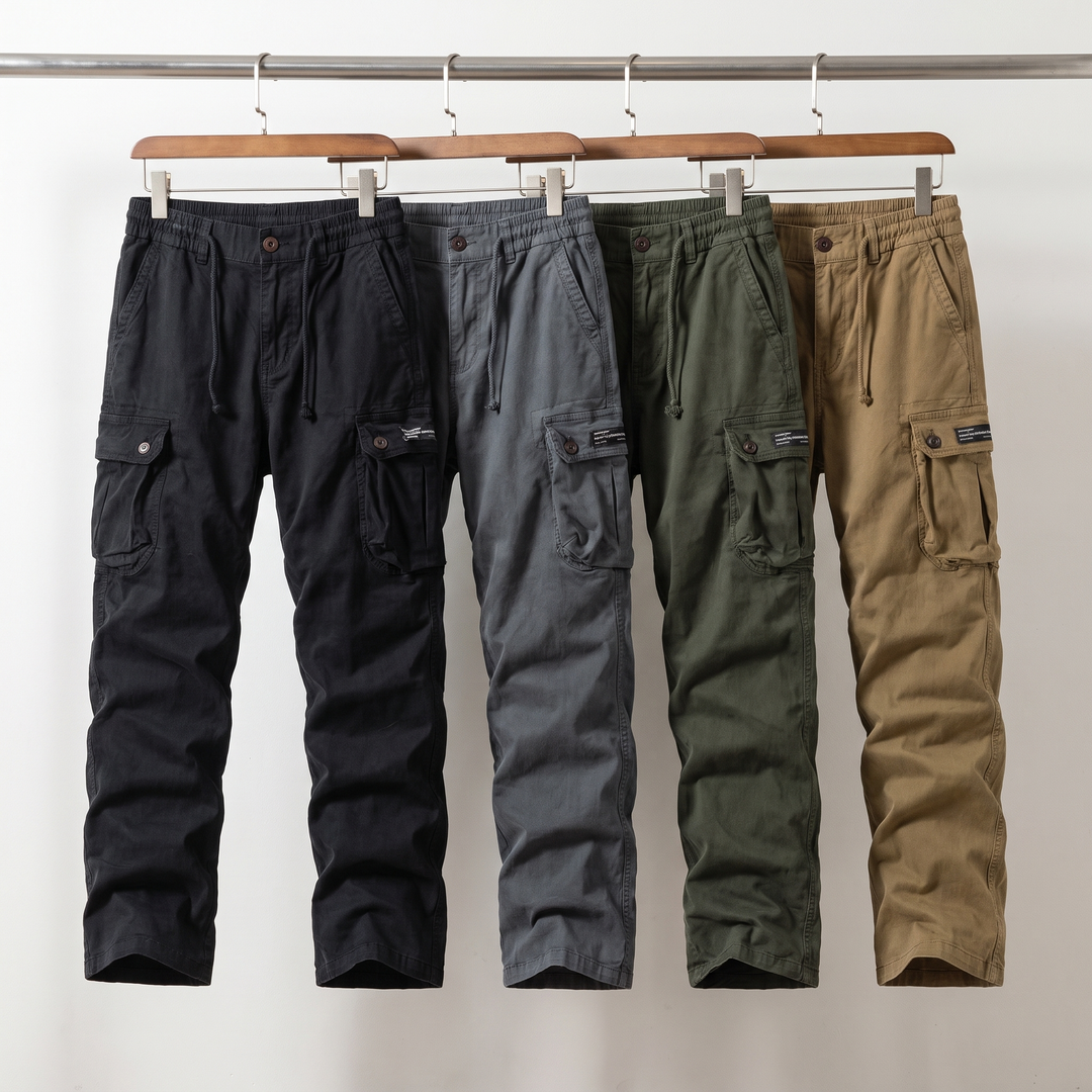 Cotton cargo pants in black, gray, army green and camel hanging side by side on a rail