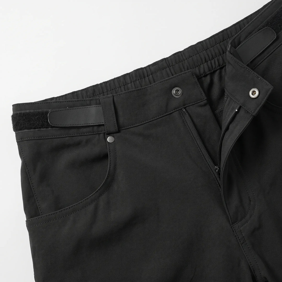 Close-up of the snap button, zip fly and hook-and-loop waist adjuster