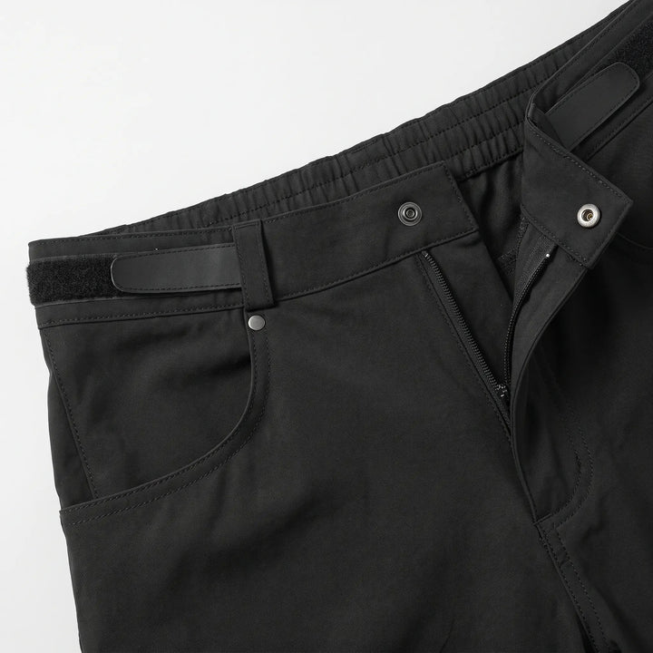 Close-up of the snap button, zip fly and hook-and-loop waist adjuster