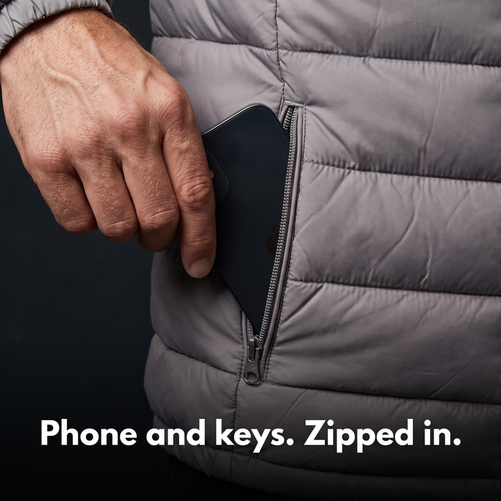 Phone going into the zip hand pocket of the puffer jacket