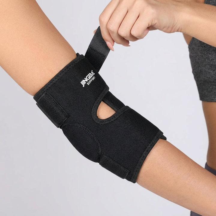 Adjustable neoprene elbow wrap in Black worn on the arm