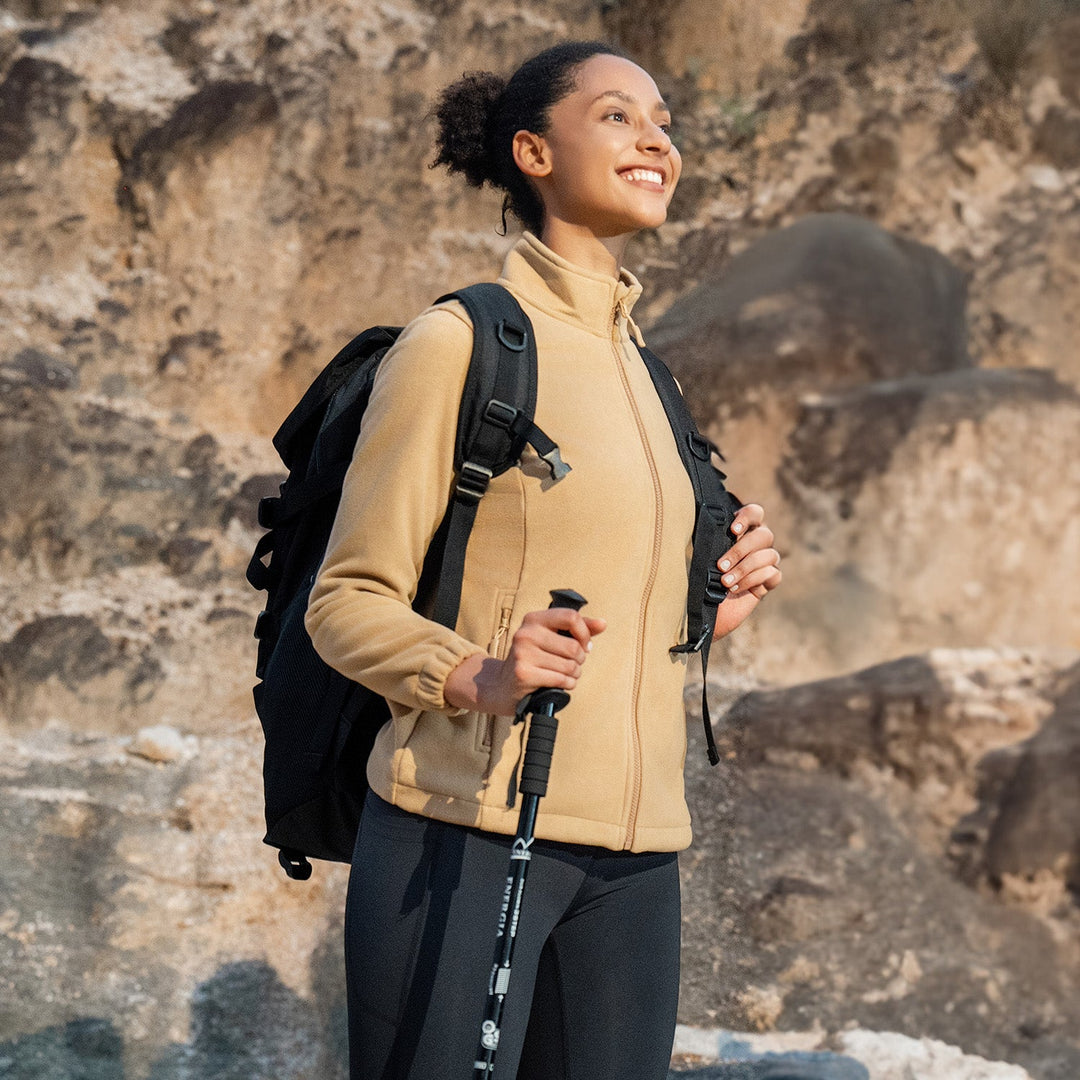 Woman hiking in the women's fleece jacket in Beige