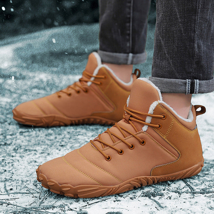 Winter barefoot shoes in tan with fleece trimmed collar worn in the snow
