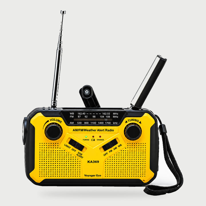 Yellow wind up radio with AM FM dial, hand crank, reading lamp, telescopic antenna and wrist strap