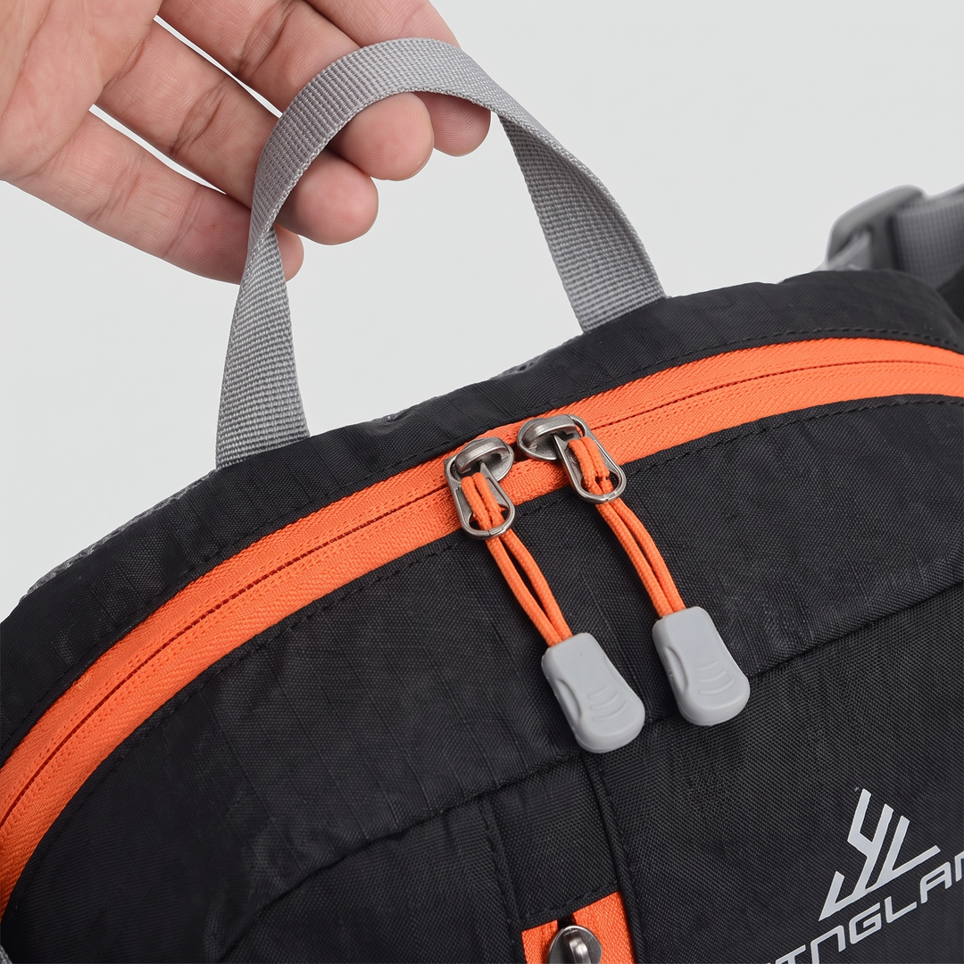 Close-up of the waist pack grab handle and main zipper pulls