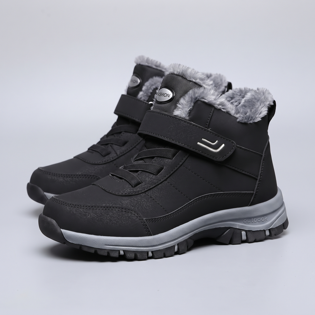 Plush lined winter boots for men and women in black, pair on light gray background