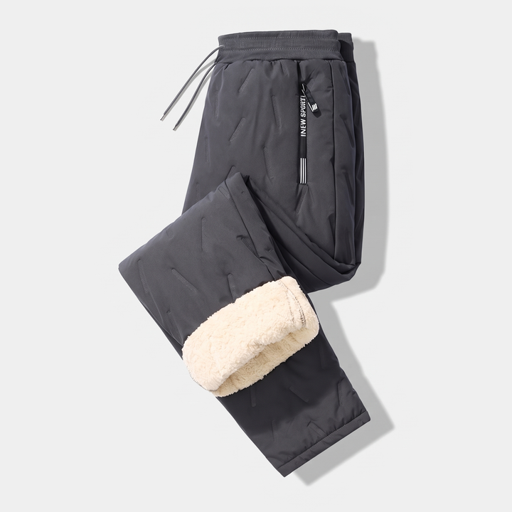 Men's sherpa fleece lined joggers in Dark Gray, laid flat with one leg folded to show the lining