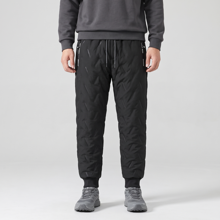 Men's sherpa lined joggers in Black worn with trail shoes, front view showing ribbed cuffs