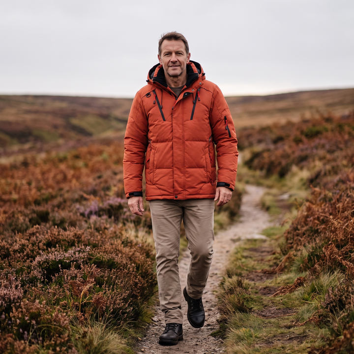 Man wearing orange Men's Puffer Jacket on outdoor trail