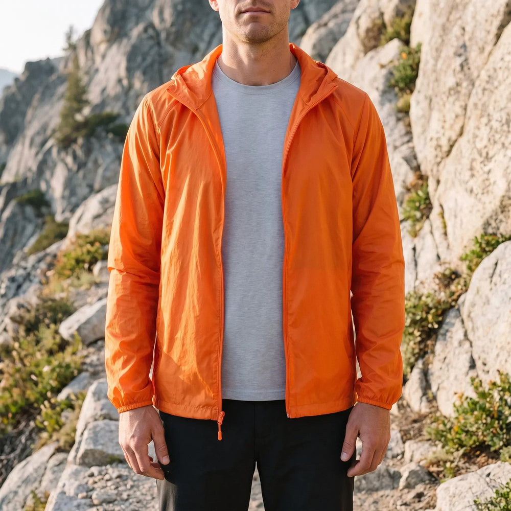 Man wearing the men's packable jacket in Orange
