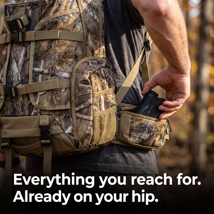 A hand drawing a rangefinder from the zipped hip belt pouch with the pack still on