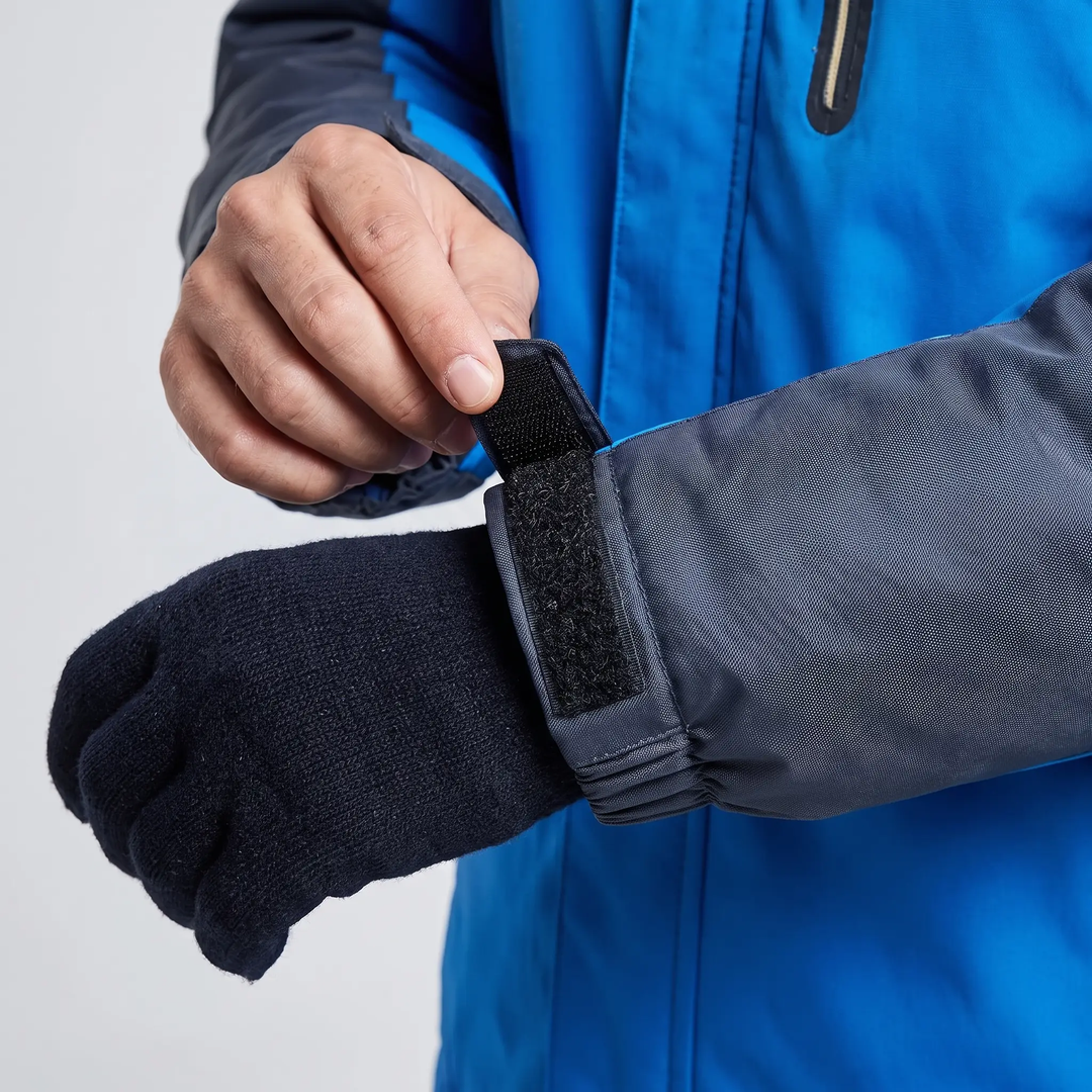 Hook-and-loop cuff tab closed over a glove on a men's ski jacket