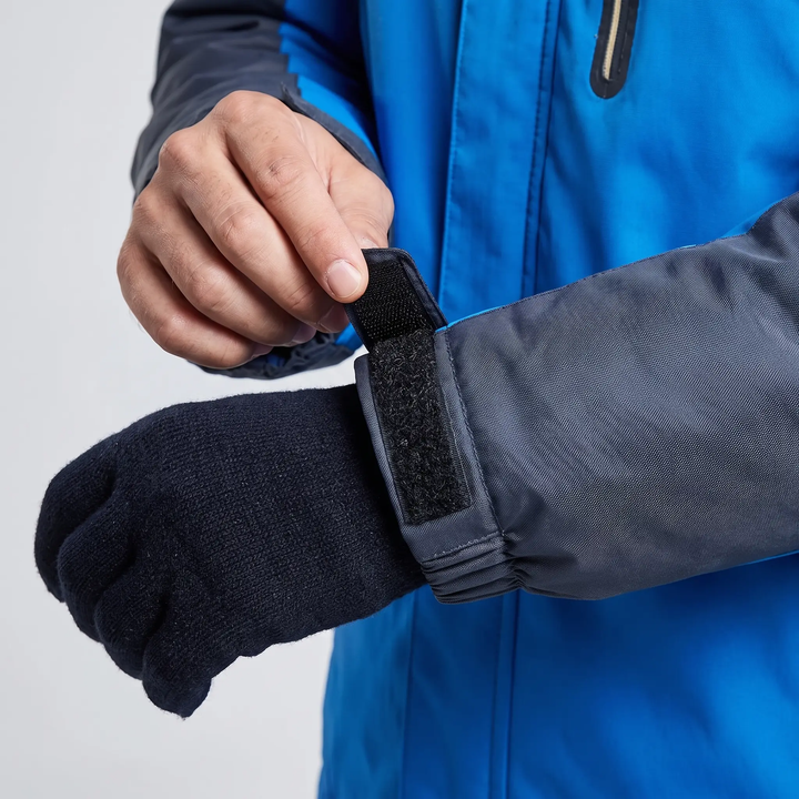 Hook-and-loop cuff tab closed over a glove on a men's ski jacket