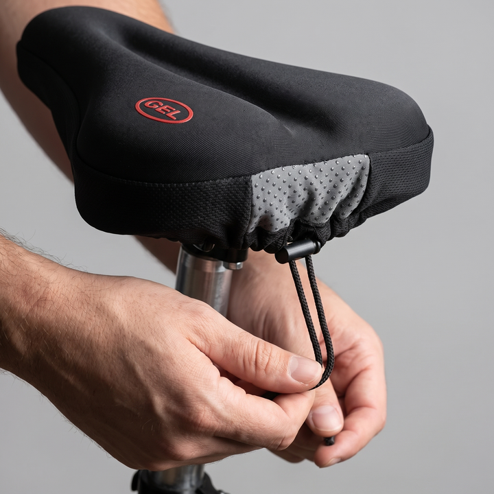 Hands pulling the drawstring tight under the saddle to fix the bike seat cover in place