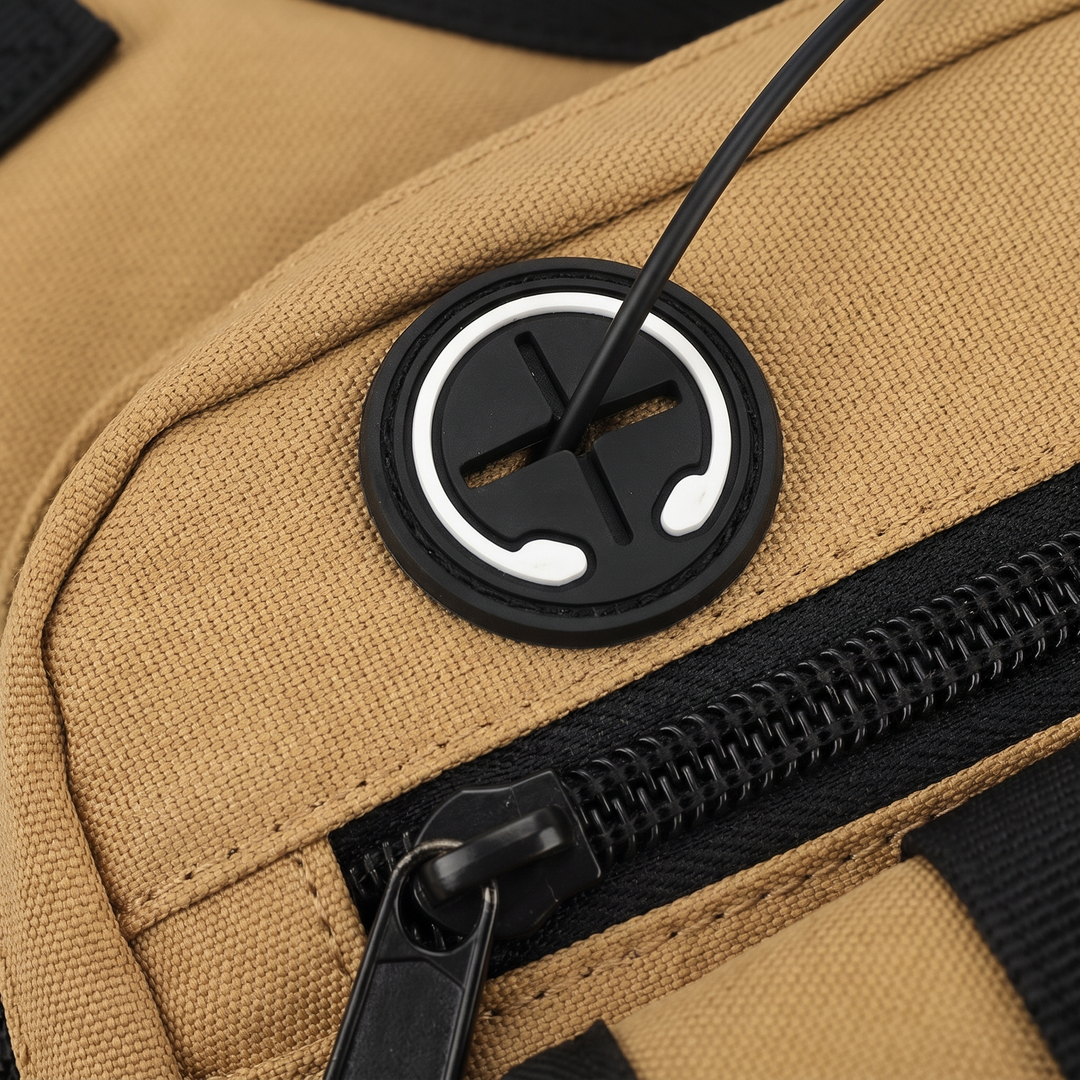 Macro of the rubber headphone port with a cable running out