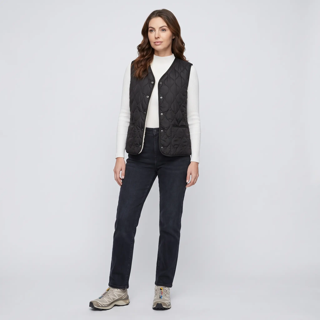 Full-length look - women's Black puffer vest with jeans and sneakers