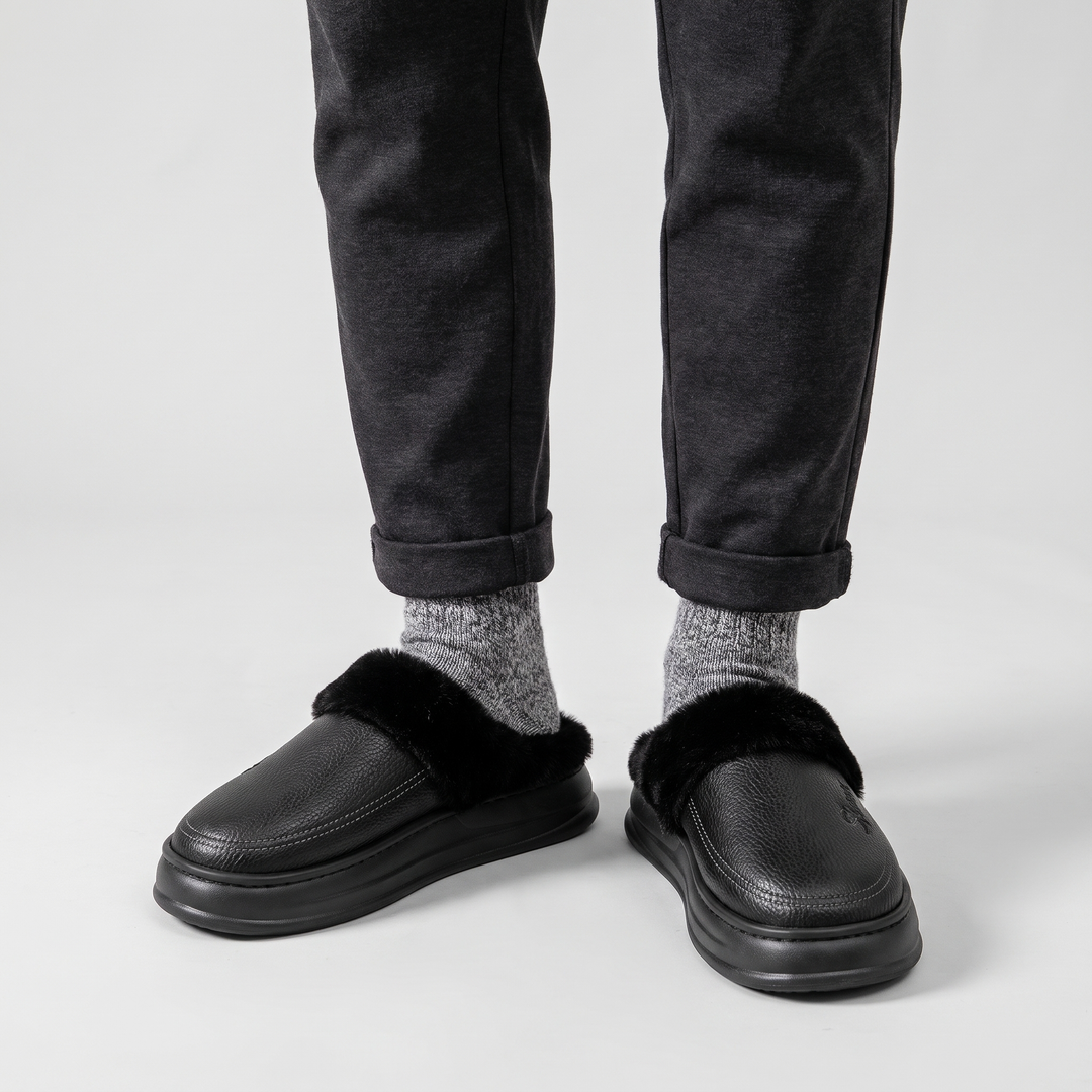Front view of the black slipper clogs worn with gray wool socks