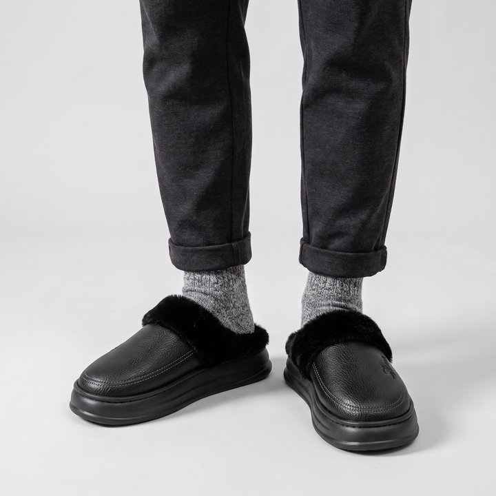 Front view of the black slipper clogs worn with gray wool socks