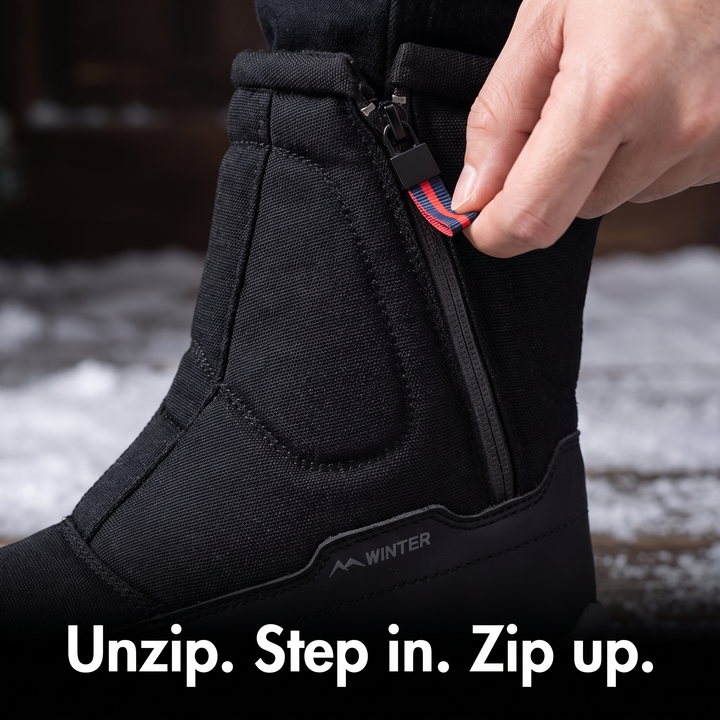 Pulling the side zip closed on the winter boot