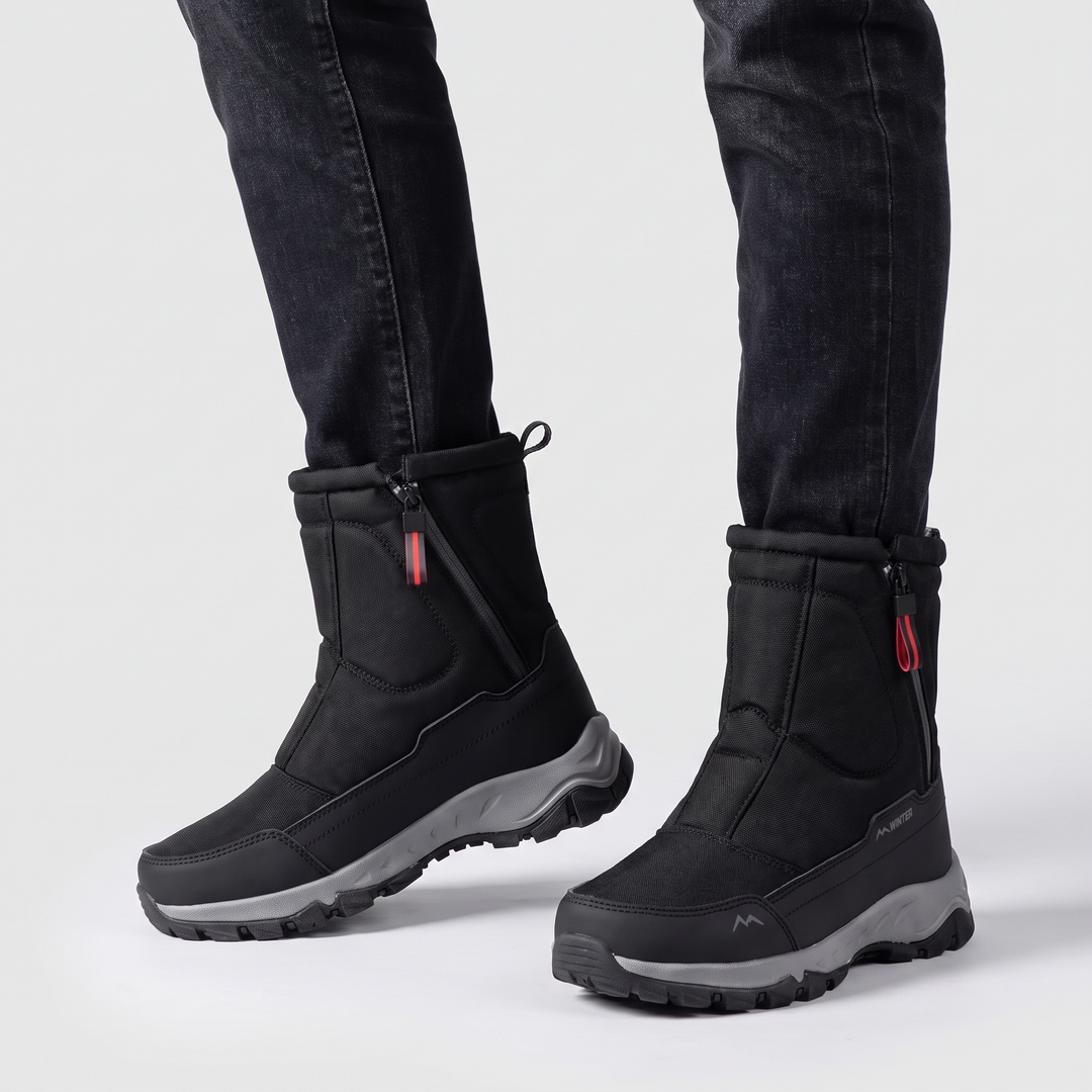 Pair of black side zip winter boots worn with dark jeans