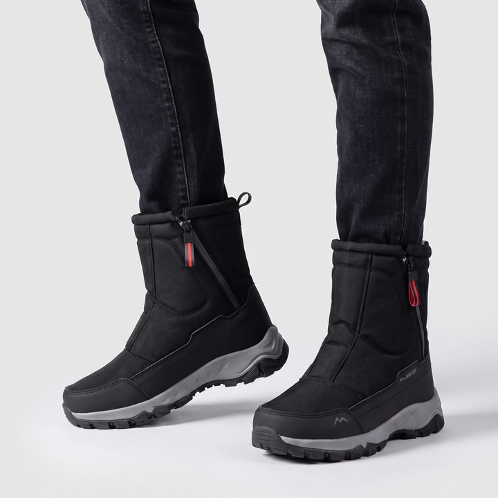 Pair of black side zip winter boots worn with dark jeans