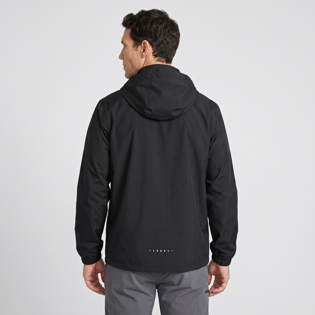 Waterproof rain jacket in Black - back view with reflective hem dots