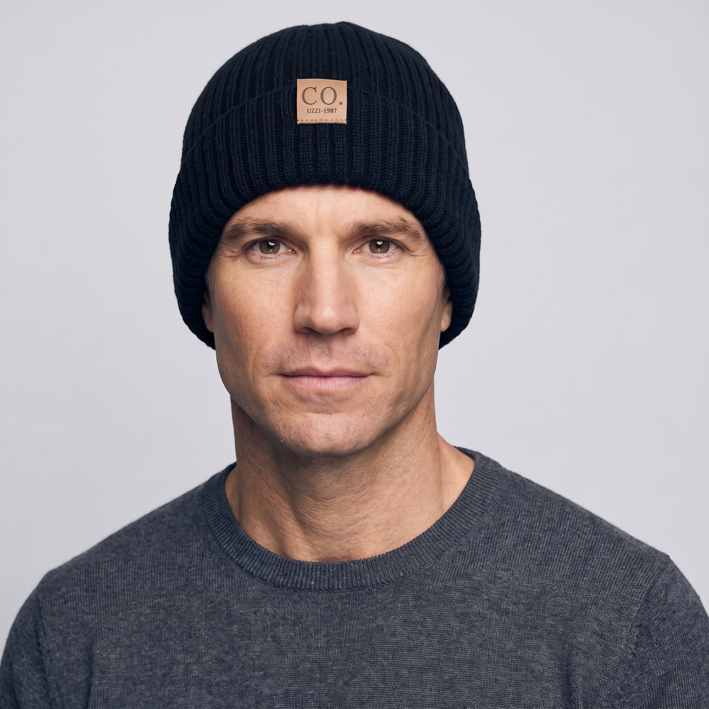 Man wearing the black beanie hat pulled down over his ears, studio front view