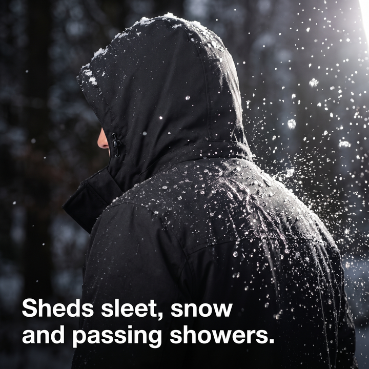 Sleet and snow beading off the shoulder of the water-resistant jacket